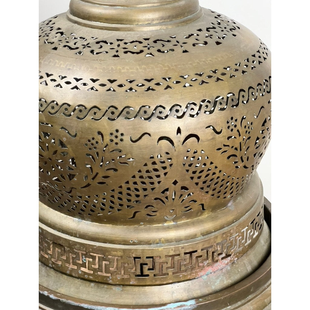 Close-up of an Antique Venetian Brass Bell Room Heater Brazier (19th Century) with intricate floral, wavy line, and geometric cutout patterns on its rounded brass surface—an elegant decorative object with antique charm.