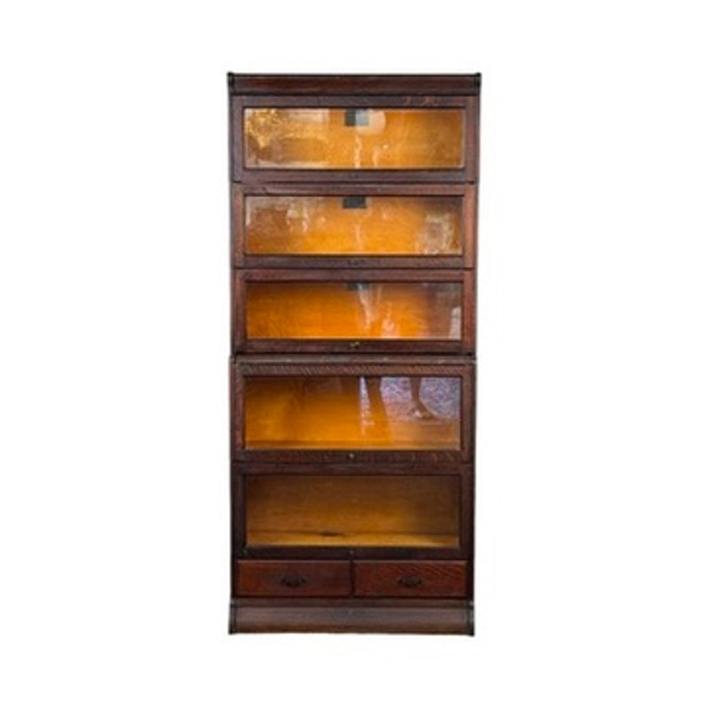 An Antique Hale System Quarter-Sawn Oak Five-Stack Barrister Bookcase by Camden Cabinet Company, c. 1910, featuring five glass-fronted shelves and two small drawers at the bottom, is shown against a white background.