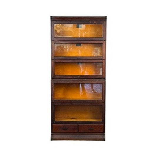An Antique Hale System Quarter-Sawn Oak Five-Stack Barrister Bookcase by Camden Cabinet Company, c. 1910, featuring five glass-fronted shelves and two small drawers at the bottom, is shown against a white background.