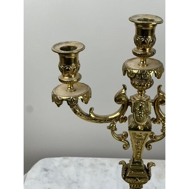 A close-up of an Antique Pair Late 19th Century Brass Three Light Candelabra with ornate detailing, displayed on a white marble surface against a light gray background—ideal for infusing Victorian charm into your decor. Brand: Unknown.