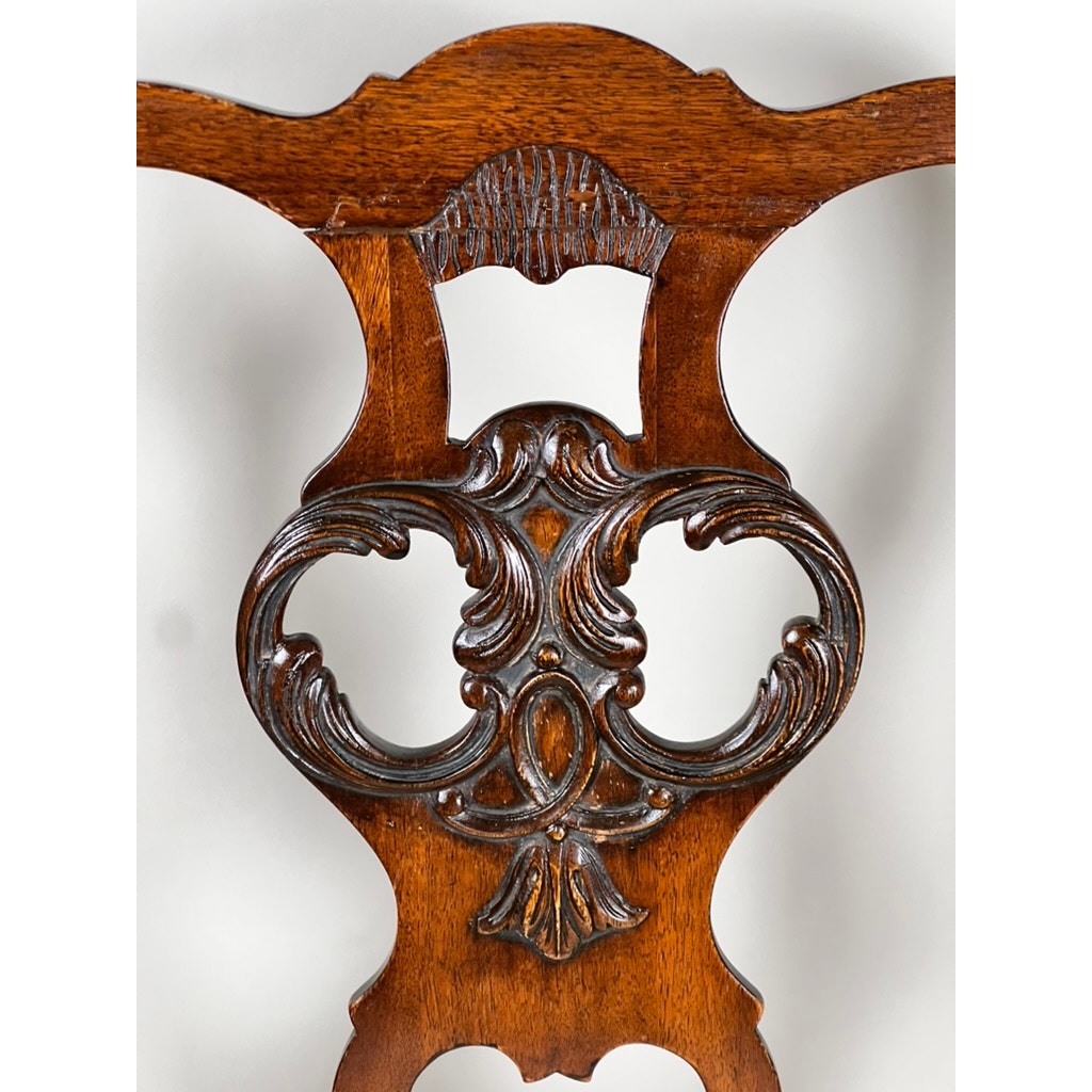 Antique George III Mahogany Open Arm Chair, late 18th century, with ornate scrollwork, curved symmetrical patterns, and a polished brown finish inspired by classic Chippendale design. Brand unknown.