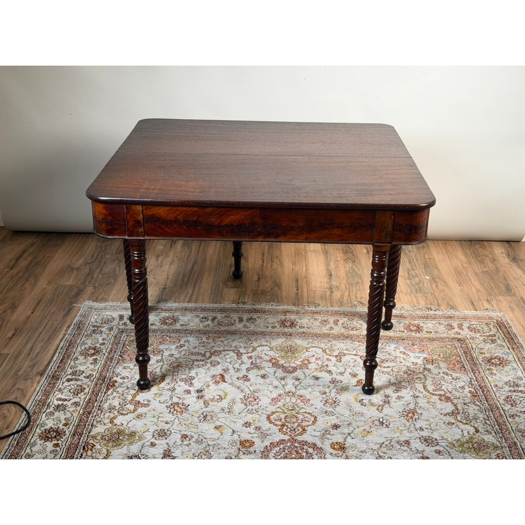 An American Classical Mahogany Single Drop-Leaf Table with Spiral-Twist Legs, c. 1830–1845 by Pearl City Antiques stands on a patterned area rug atop a wood floor against a plain white wall.