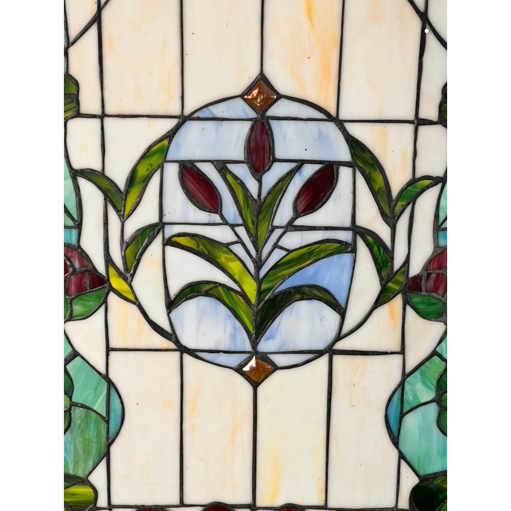 The Vintage Stained Glass Wall Hanging 32x20 features a central circular design with red tulip-like flowers, green leaves, and geometric borders in pastel glass panels. Brand: None and/or Unknown.