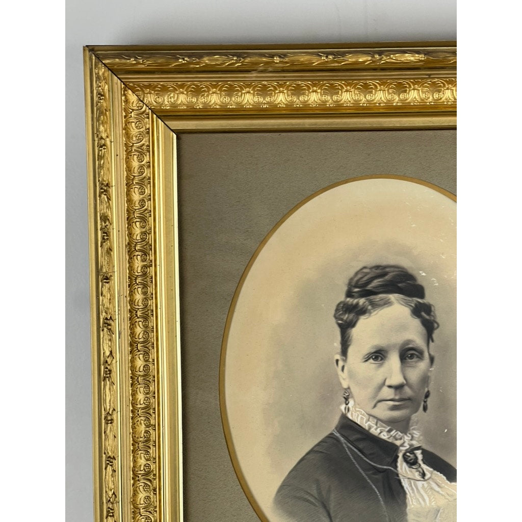 A partial view of the Antique Civil War Era Portrait of a Woman in Gilt Wood Frame shows the left side of this elegant sepia portrait, featuring a styled-haired woman in a lace-detailed high-neck dress. Brand: None/Unknown.