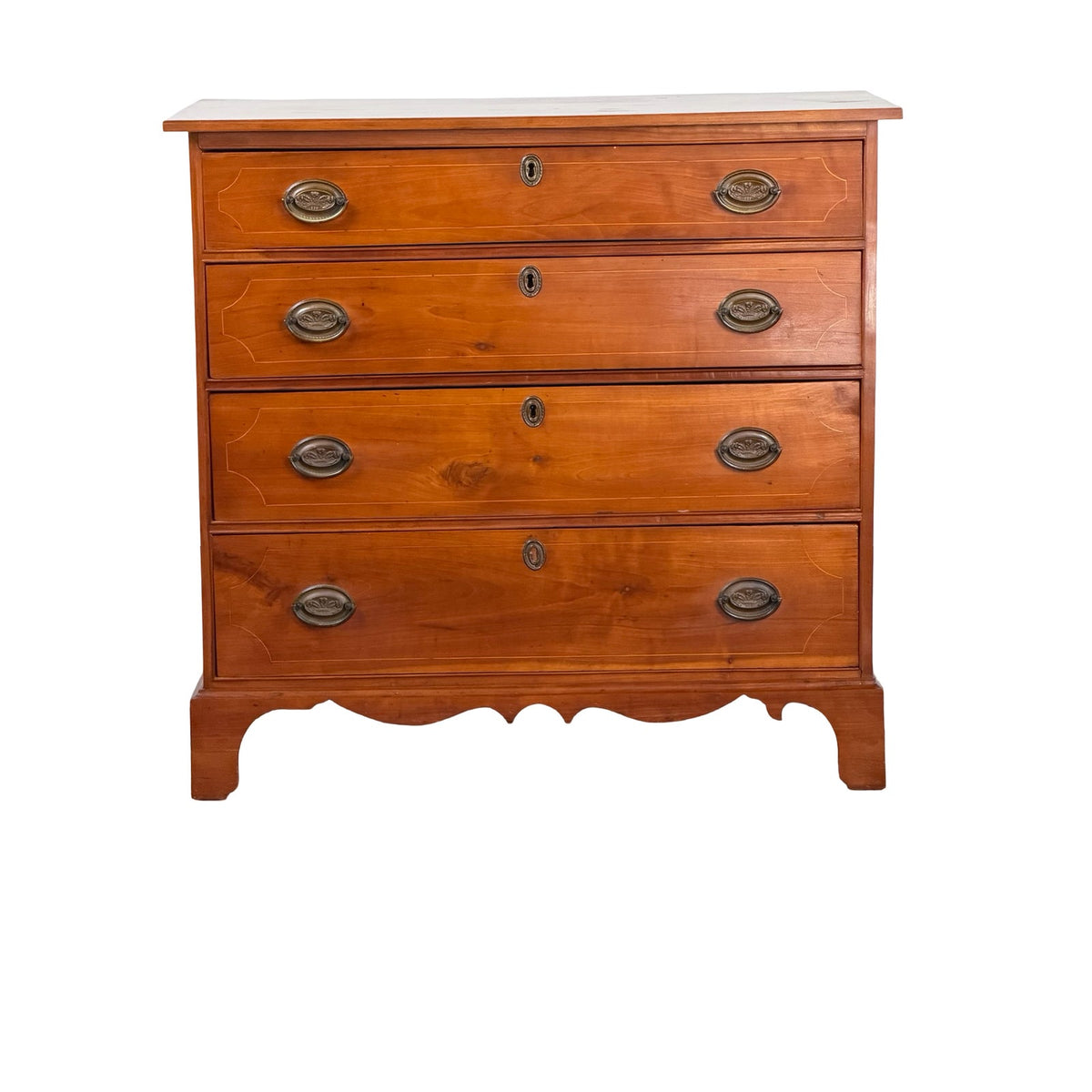 Pennsylvania Federal Cherry Four-Drawer Chest with Satinwood String Inlay, circa 1800–1820, featuring four drawers, brass pulls, oval keyhole escutcheons, and a scalloped base.