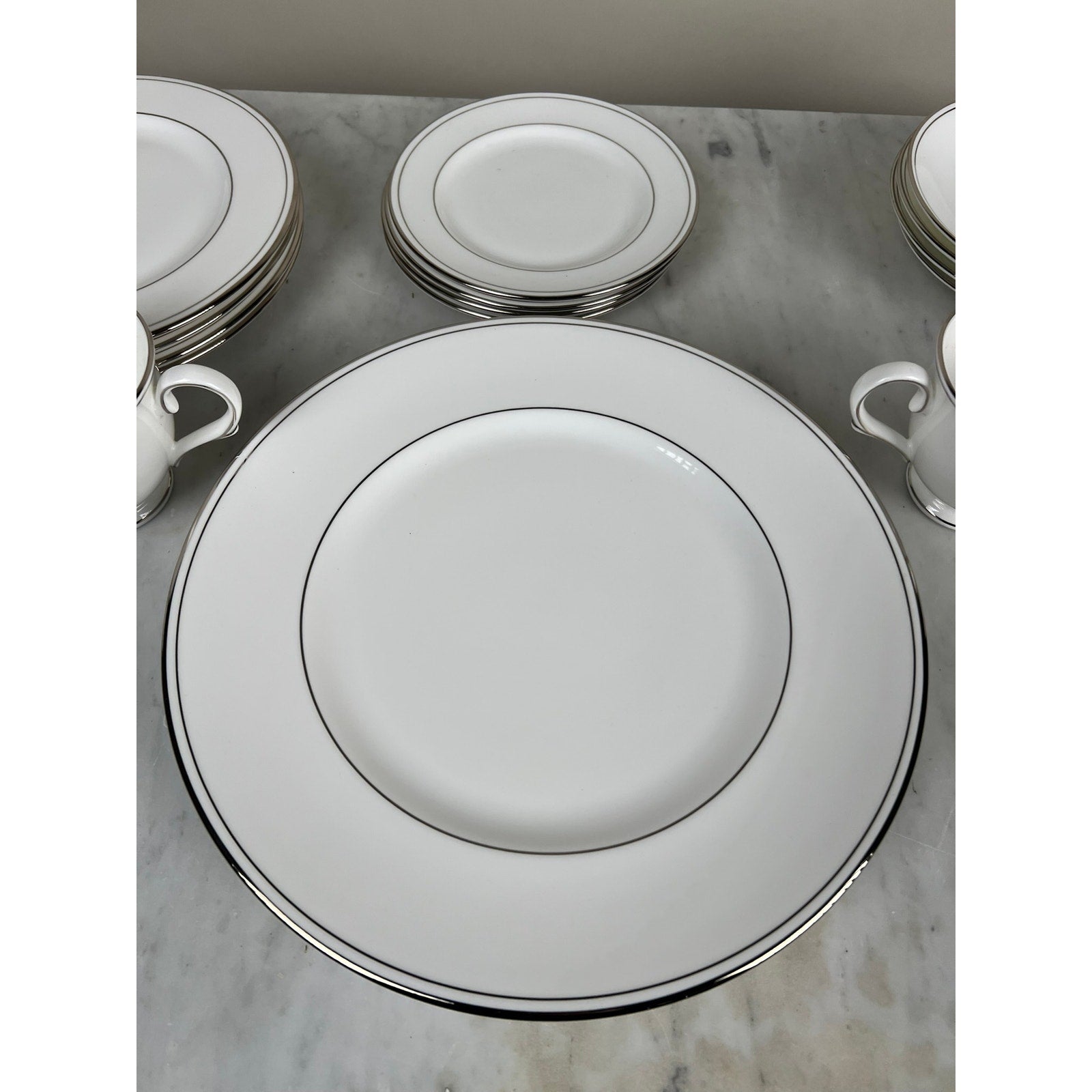 Vintage Lenox Federal Platinum Fine English Bone China Service for Four by Lenox features elegant plates, cups, and saucers with silver trim—ideal for those who love classic vintage tableware.