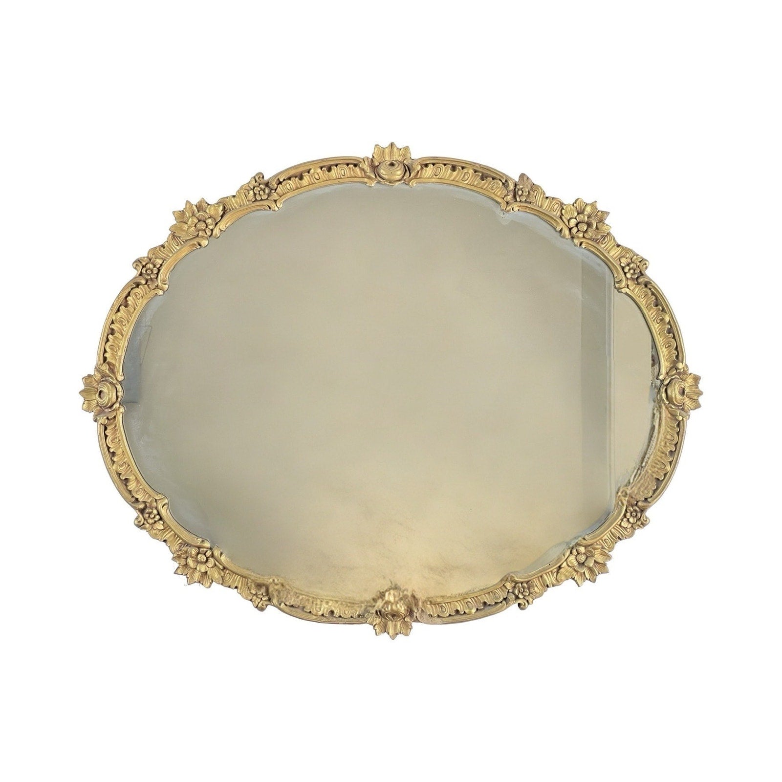 The Antique Gilt Wood Oval Mirror c. Early 20th Century features a gold decorative frame with floral and leaf motifs, making it an elegant classical revival accent for sophisticated interiors.