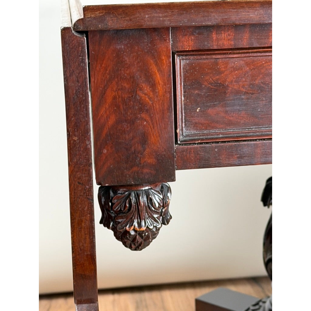 Close-up of an American Classical Carved Mahogany Drop-Leaf Breakfast Table, c. 1825–1840 Possibly New York or Philadelphia, showing carved acanthus leaf detailing at the top of the leg.