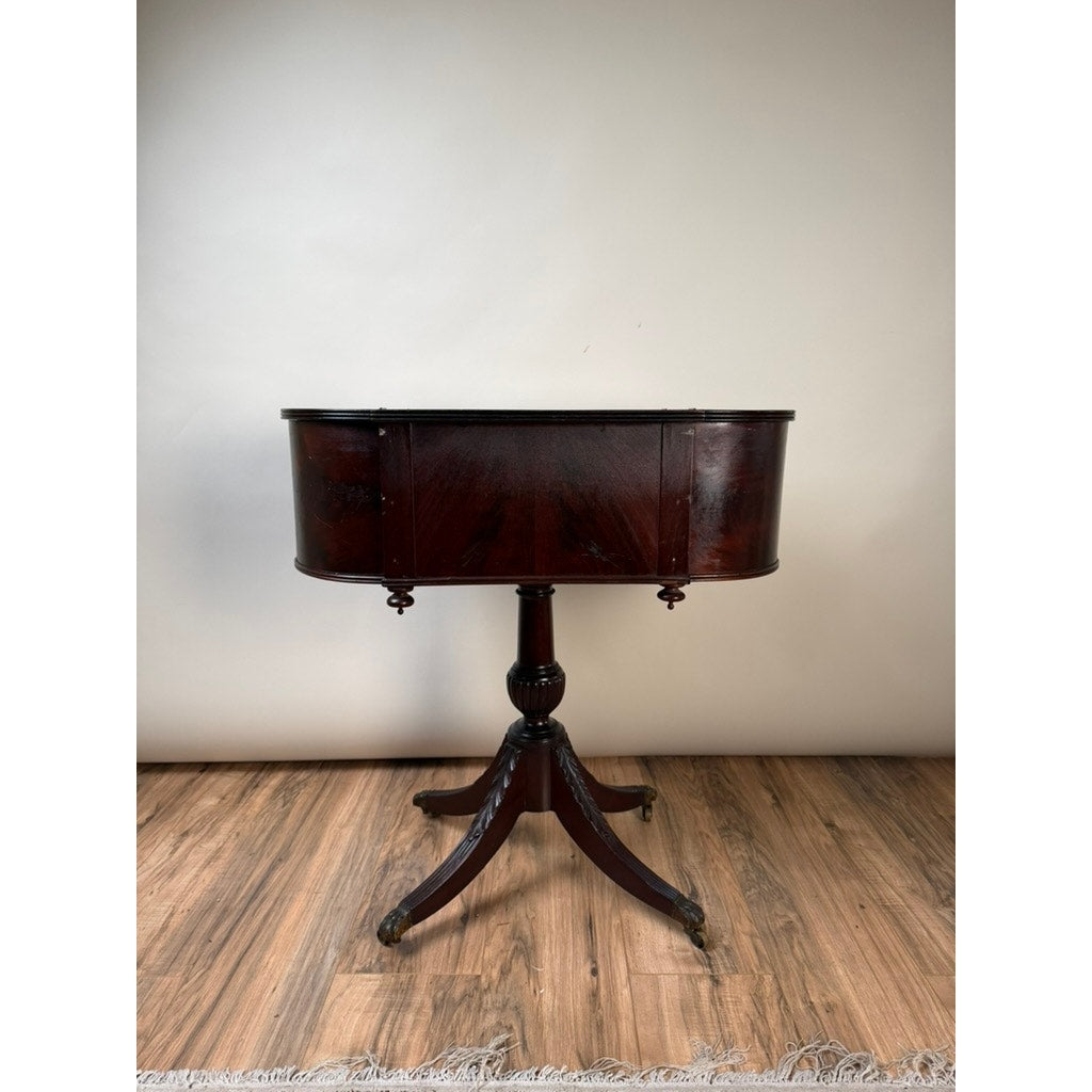 Early 19th Century New York Classical Mahogany Astragal-End Work Table in the manner of Duncan Phyfe, c. 1815–1825, featuring a rounded rectangular top with a rich, dark polished finish. This elegant piece stands on a central pedestal supported by four gracefully curved legs and is displayed on a wooden floor against a plain light background.