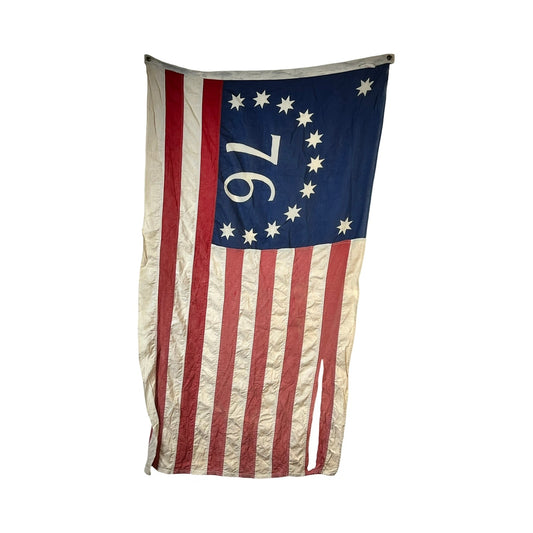 Showcasing classic Americana, this Vintage Valley Forge “76” Bennington American Flag from the Bicentennial era (c. 1976) displays 13 red and white stripes, a blue canton with 13 stars in a circle, and the prominent white number “76”—a tribute to the year 1776. Brand: None/Unknown.