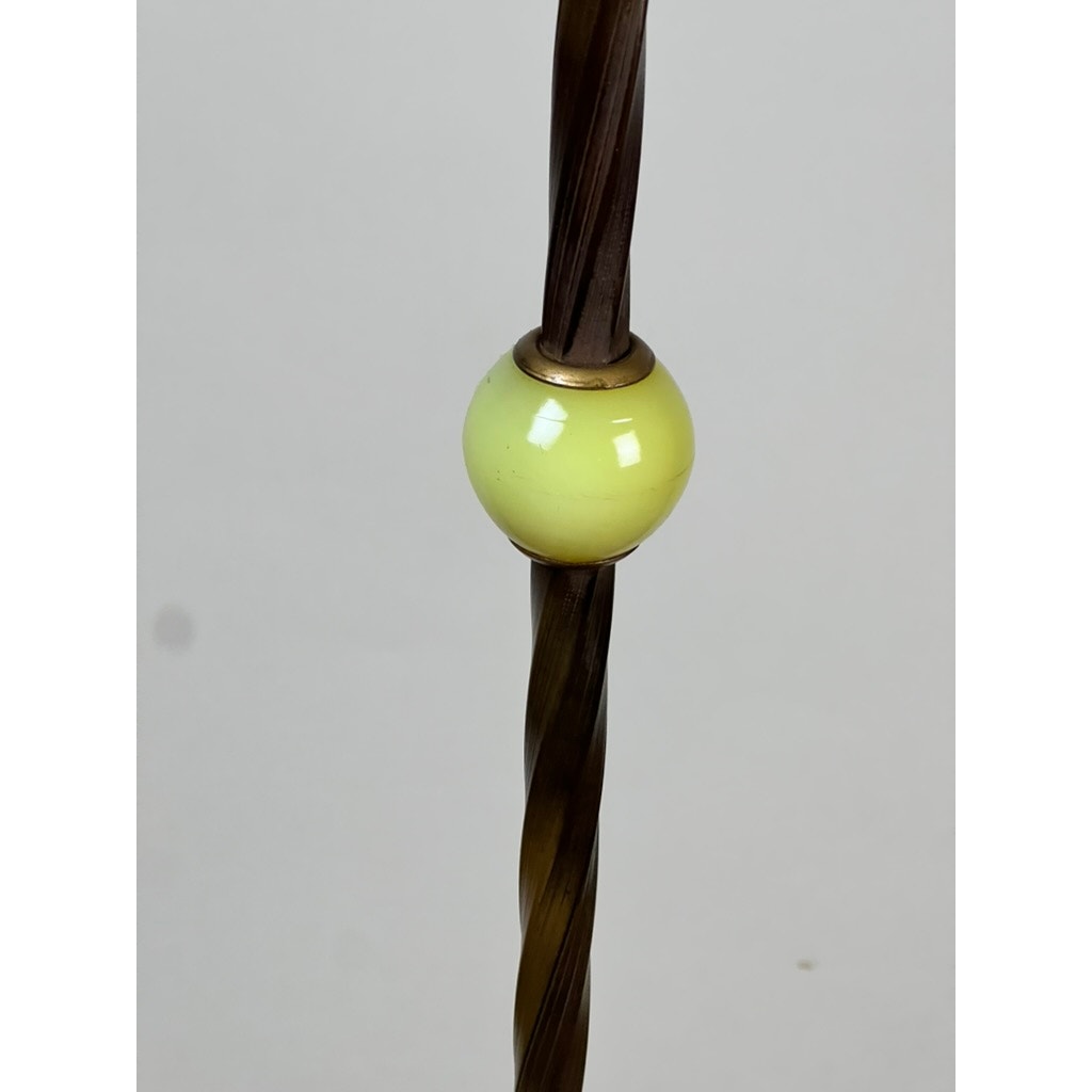 Close-up of an Antique Art Deco Uranium and Slag Glass Lamp c. 1920 featuring a twisted, dark brown rod with a shiny pale yellow uranium glass bead, shown against a plain light gray background. Brand: Unknown.