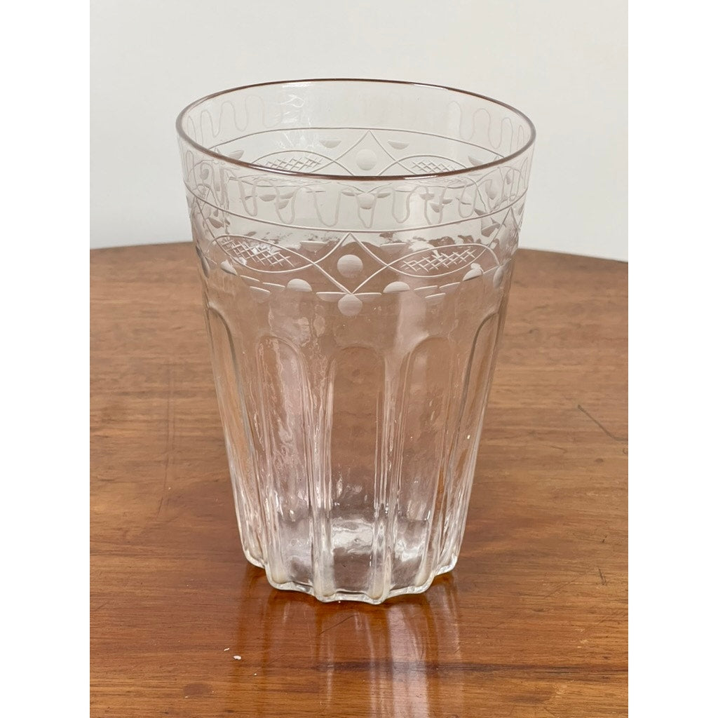 An Attributed Boston & Sandwich wheel-engraved, mold-blown glass table vase, circa 1845–1860, featuring intricate etched patterns, rests empty on a wooden surface against a plain light background—reflecting the refined craftsmanship characteristic of Victorian-era art glass.
