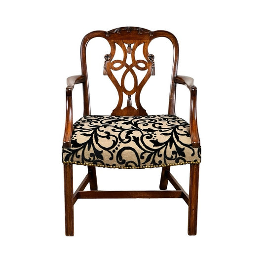Antique George III Chippendale Open Arm Chair, early 19th century, with ornate carved backrest, curved arms, and a seat upholstered in beige fabric with a black swirling floral pattern; classic English antique style.