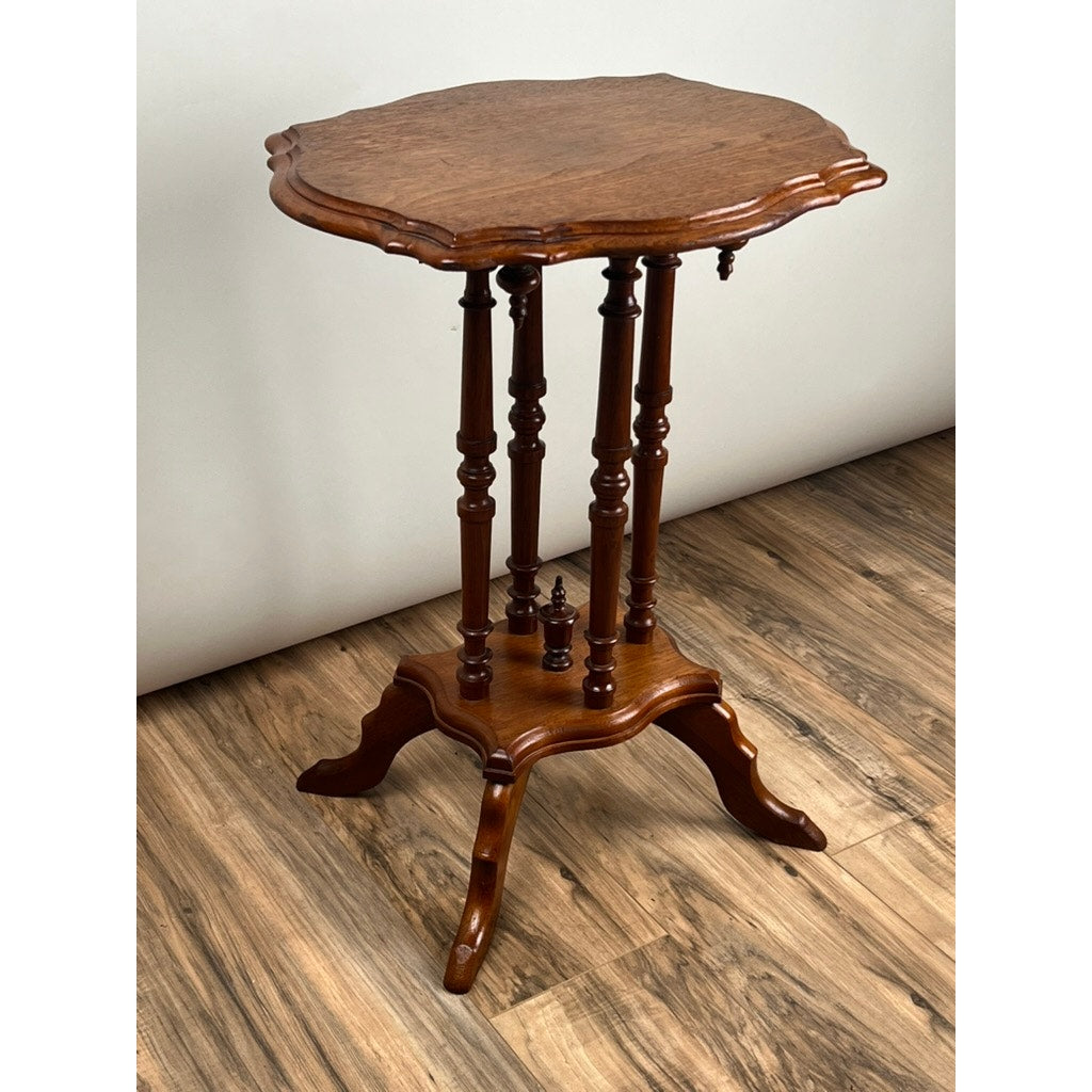 The Antique Victorian Walnut Turtle Top Candle Stand, circa late 19th century, features an ornate scalloped top on four turned legs with decorative spindles and a four-legged base, showcasing classic elegance on a wood floor.
