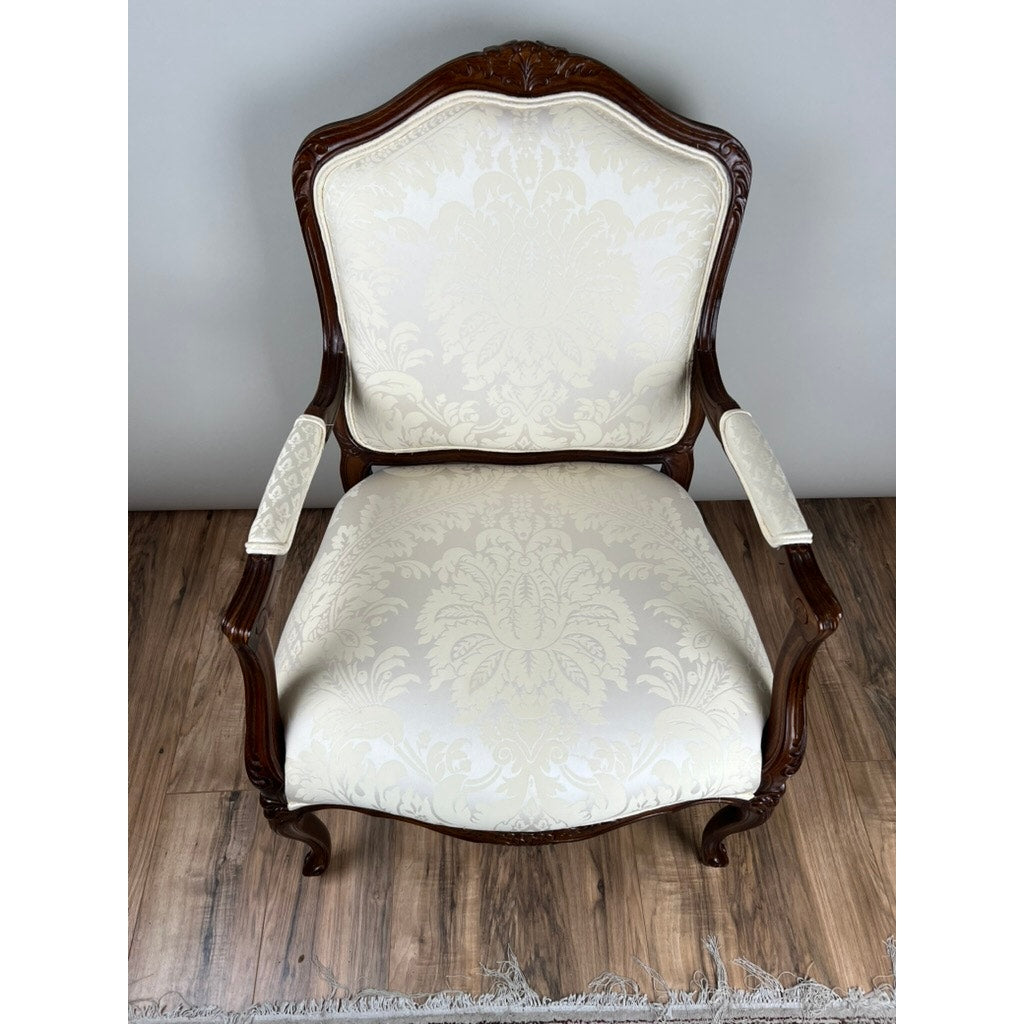 Vintage Louis XV Style Fauteuil Arm Chair by Pennsylvania House, featuring ornate carvings and cream damask upholstery, shown on a wooden floor against a plain background.