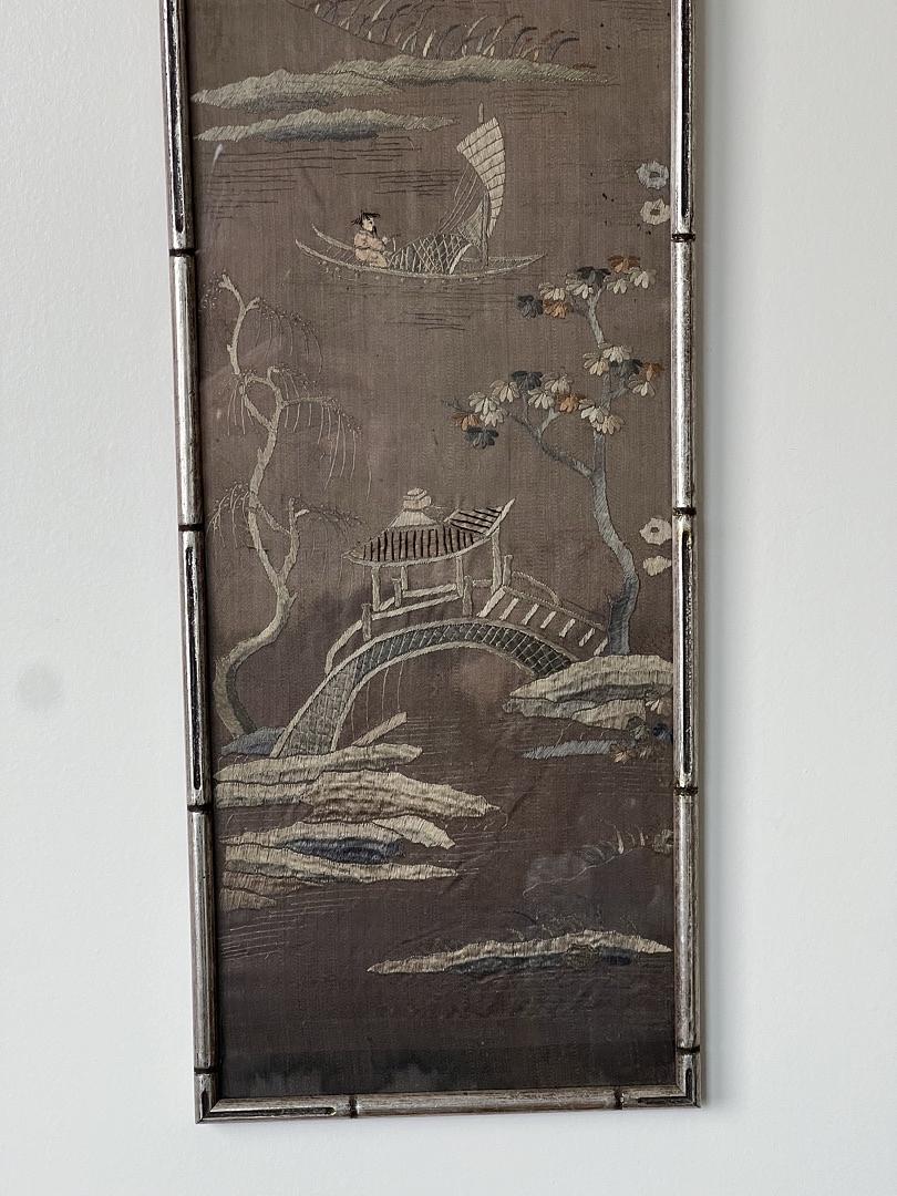 Pearl City Antiques' Antique Chinese Embroidered Panel on Silk (late 19th century) features a boat scene, curved bridge with figure, trees, flowers, and clouds in earthy tones, all bordered with metallic thread.