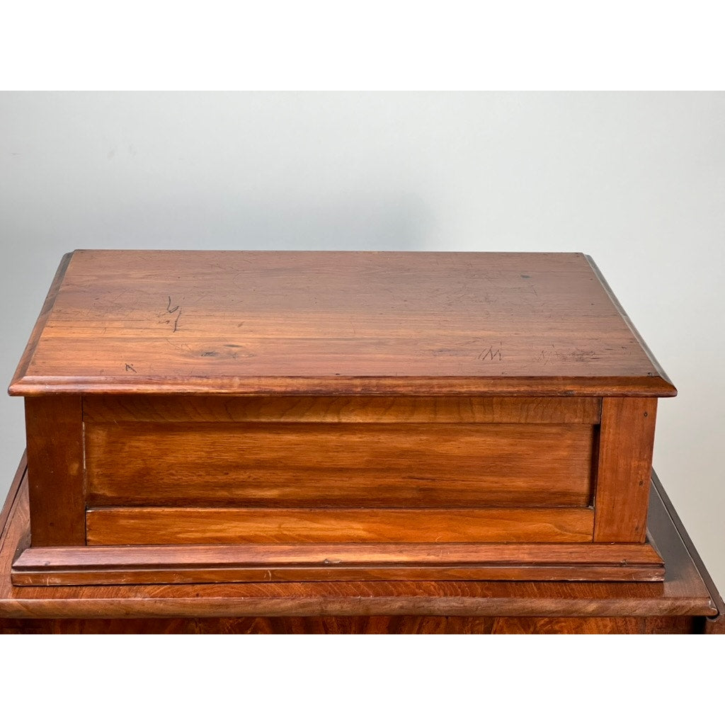 An Antique Victorian Pine Two Drawer Clark’s O.N.T Spool Cabinet from the late 19th century by Clark's ONT, featuring a smooth, polished finish and classic design, rests atop a wooden surface as a vintage storage or keepsake box.