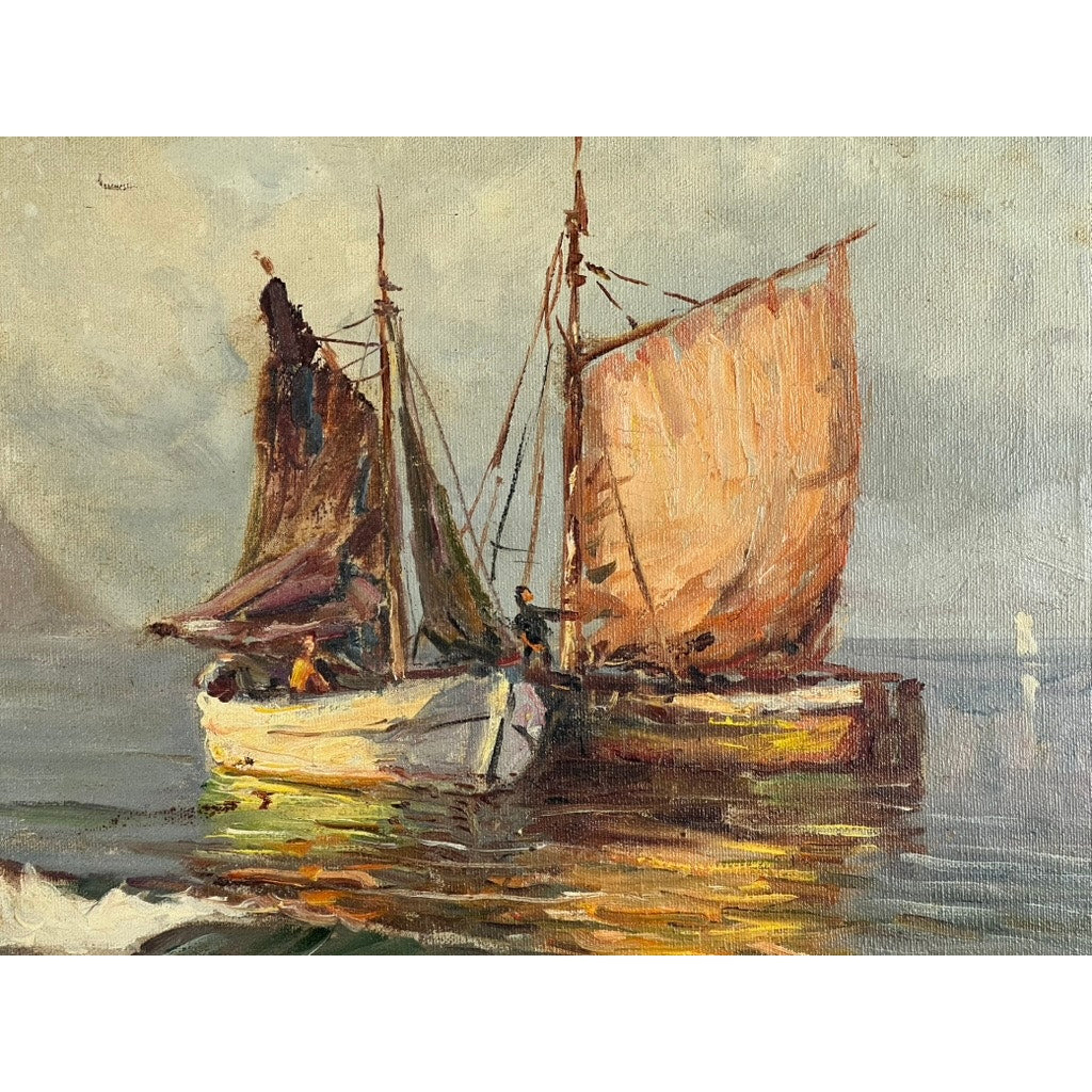 “Two Ships Off the Beach” is an oil on canvas painting depicting two sailboats with vibrant sails and visible figures on calm water at sunrise or sunset, set against a cloudy sky and misty coastline. Signed lower left; artist unknown.