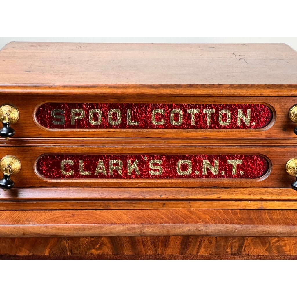 Antique Victorian pine two-drawer Clark’s O.N.T spool cabinet, c. late 19th century; features “Spool Cotton” and “Clark’s O.N.T.” in gold on red—a charming collectible for Clark’s ONT brand enthusiasts.