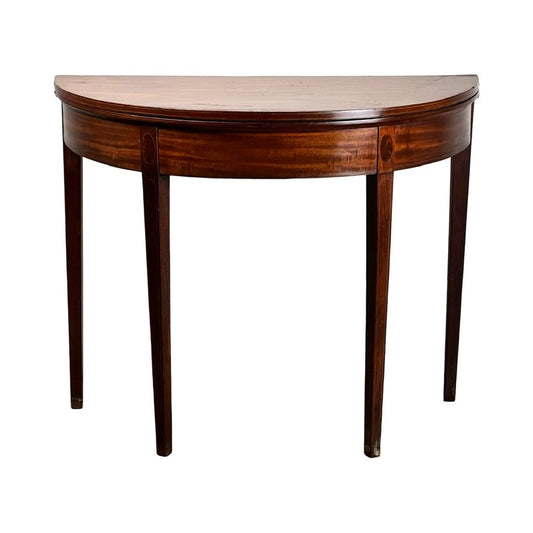 The Antique Hepplewhite Mahogany Demilune Game Table (c. Mid 19th Century) boasts a smooth mahogany surface, four straight legs, and a rich dark brown finish. Brand: Unknown.