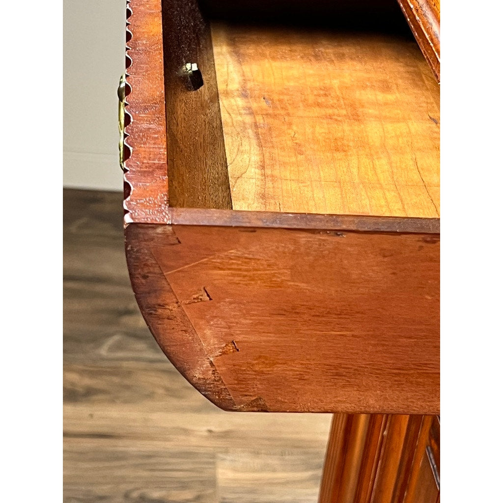 Close-up of an open drawer from an Antique English Jacobean Revival Mahogany Buffet c. 1915–1925, showing dovetail joints at the front corner and visible wood grain with some wear, set against a wooden floor background. Brand unknown.