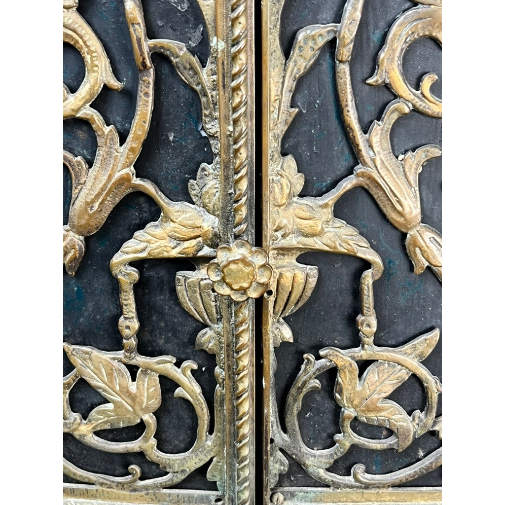 Close-up of an Antique Gothic Revival Cast Iron and Brass Phone Stand (attr. Oscar Bach or Bertram Segar, c. 1920 Greenwich Village), featuring ornate gold floral and leaf patterns with a central flower accent on a dark backdrop.