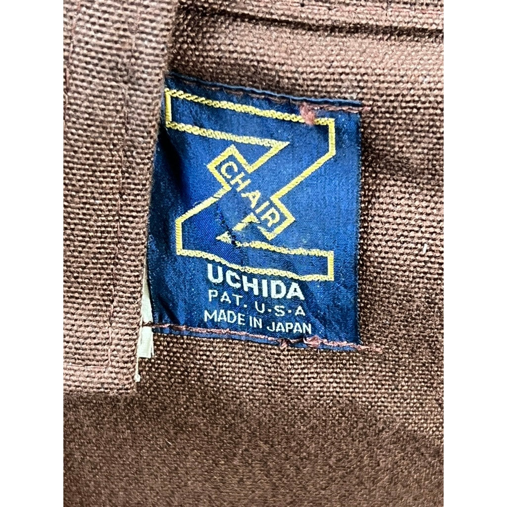 A blue and yellow fabric tag on brown material reads: Uchida Z Chair, Pat. U.S.A, Made in Japan—marking this Vintage Uchida Z Chair Japanese Modern Chrome Sling Lounge Chair with Headrest by Uchida as a true collectible and a striking example of Japanese modern design.