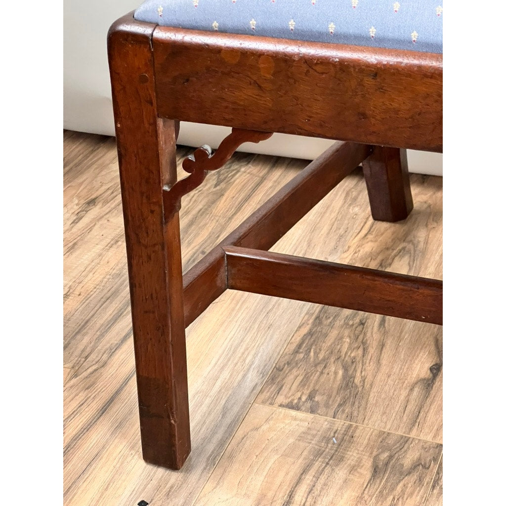 Close-up of an Antique Chippendale Walnut Open Arm Chair (Late 18th Century) with a blue upholstered seat and decorative leg support, shown on a light brown wood floor.