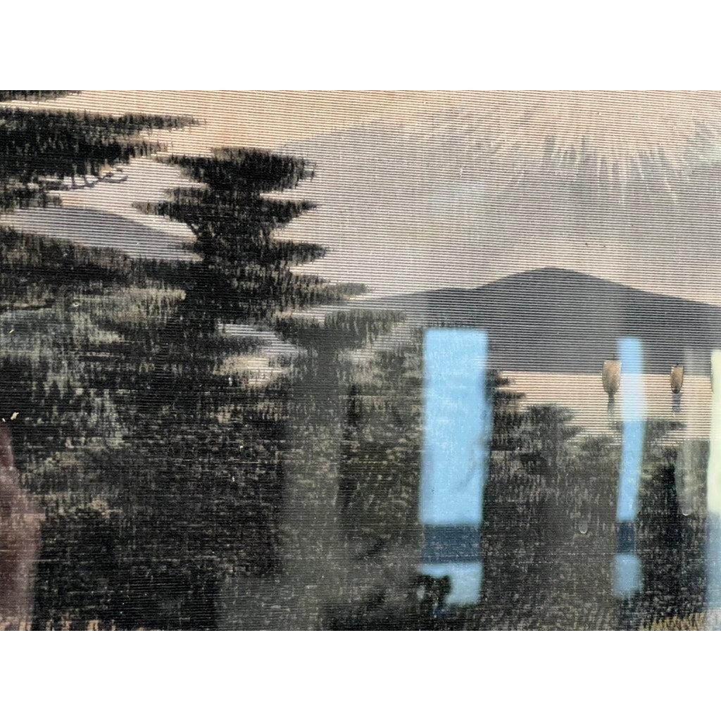 A Japanese Meiji period embroidered painting attributed to Nishimura Sozaemon of Kyoto, depicting trees and mountains by a sunset lake with blue and white reflections, reminiscent of traditional Japanese artistry.