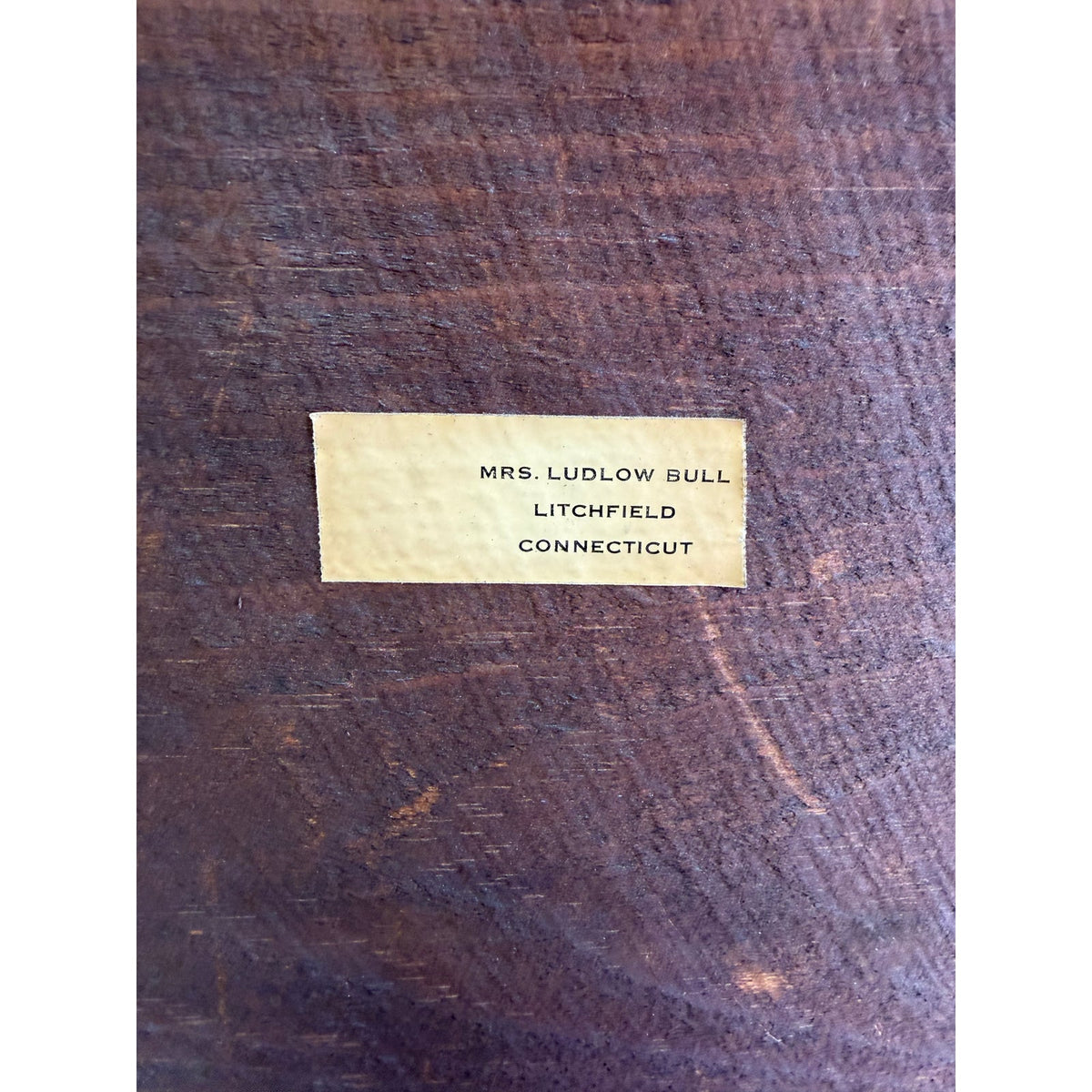 A rectangular label reading MRS. LUDLOW BULL LITCHFIELD CONNECTICUT on the dark wooden surface of an American Federal Giltwood Pier Mirror, Possibly Massachusetts or New York, circa 1815–1830.