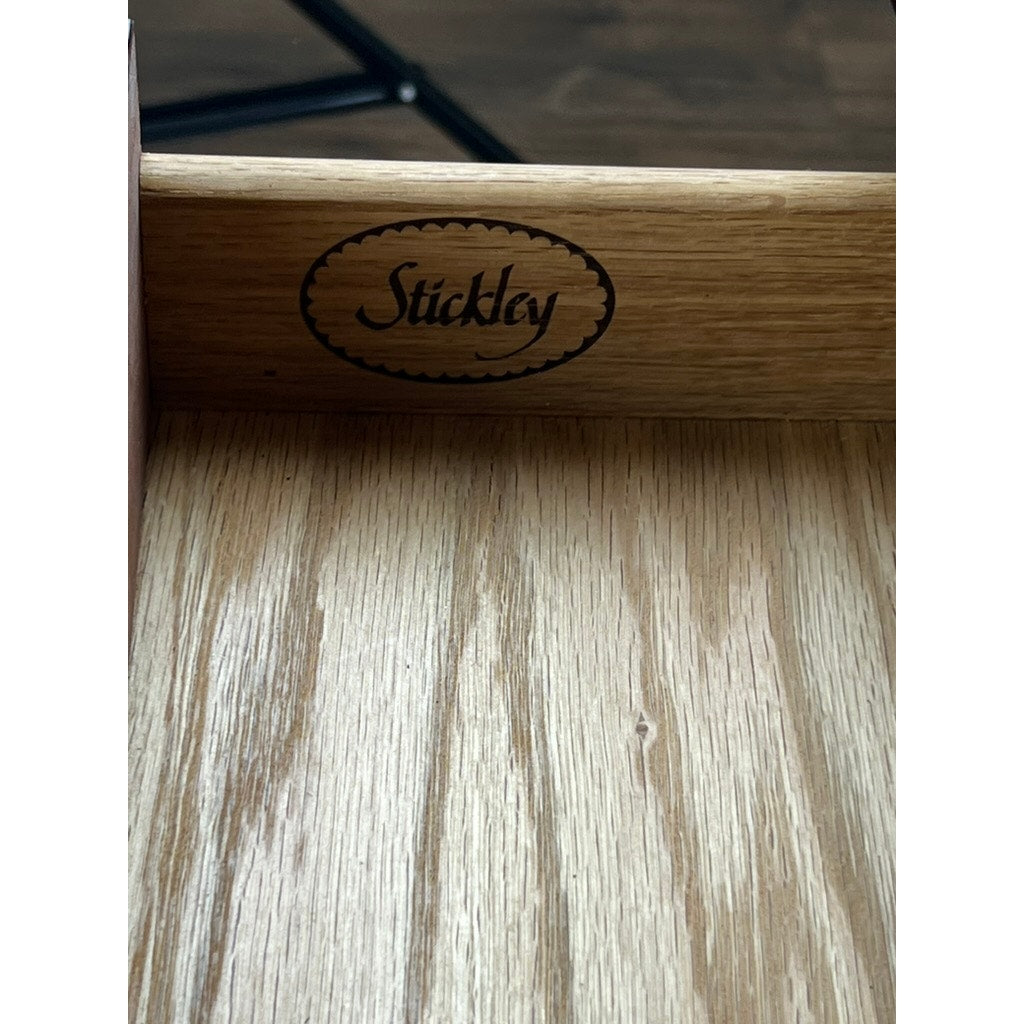 A close-up of the drawer from the Stickley Vintage Federal Style X Stretcher One Drawer End Table, featuring an engraved Stickley logo on the inner back panel and a light, natural wood finish with visible grain patterns.