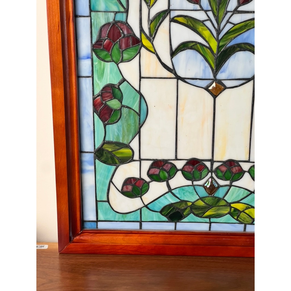 The Vintage Stained Glass Wall Hanging 32x20 features red flowers, green leaves, and blue and white panels in a wooden frame—an elegant accent for any space. Brand: None and/or Unknown.