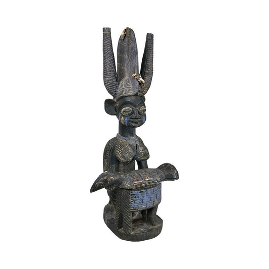 This Antique Igbo Ikenga Shrine Figure, likely from Nigeria, features intricate carved patterns, an elaborate headdress, and a rectangular object—showcasing traditional Igbo artistry. Brand: Unknown.