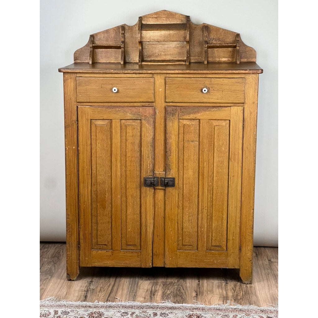 The Antique Victorian Country Grain Painted Jelly Cupboard c. 1870 features two paneled doors, upper drawers, a decorative back-shelf, and a worn finish that recalls classic grain-painted country furniture. Brand: None/Unknown.