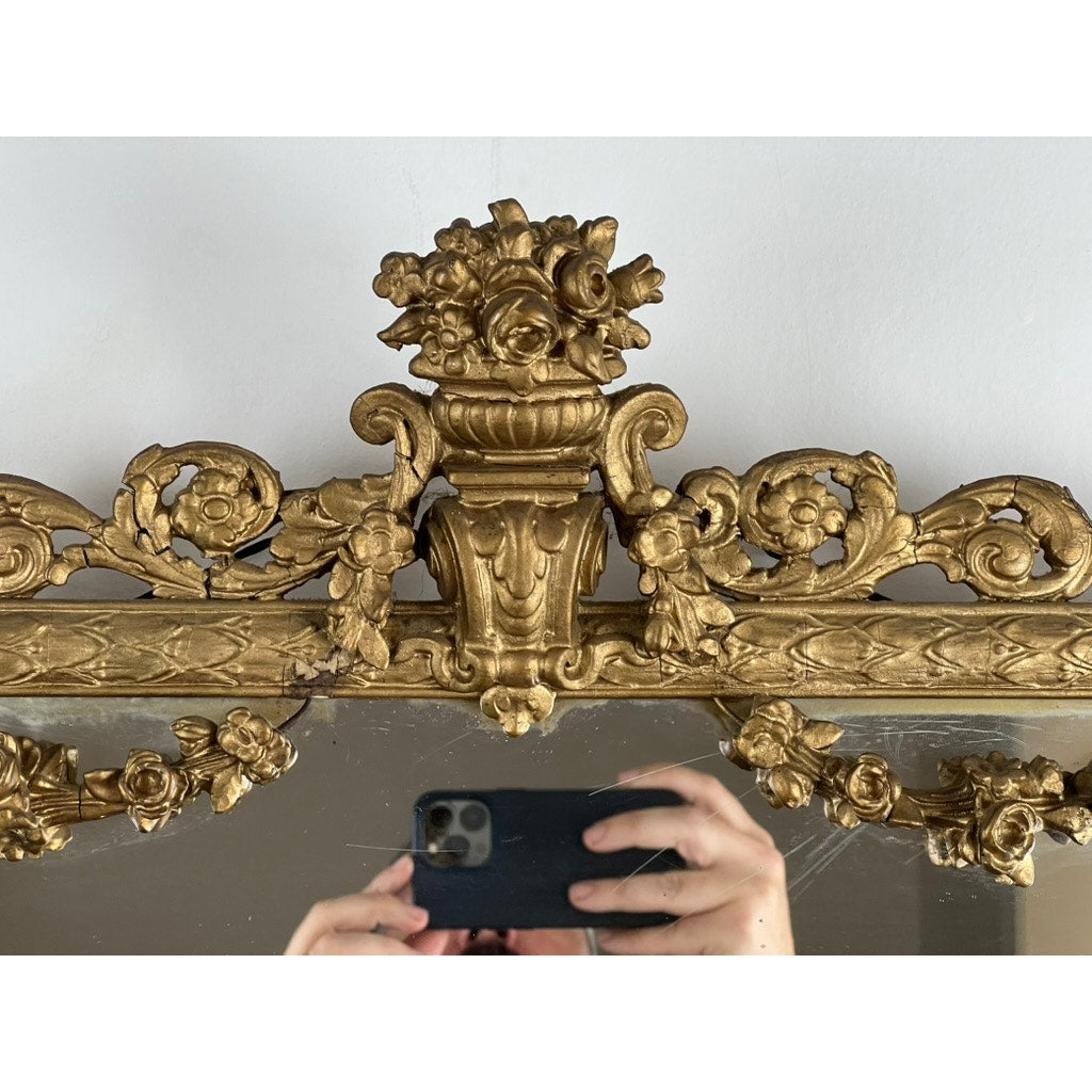 A person photographs the Exceptional Antique Louis XV Style Three Panel Mirror flanked by images of Napoleon; only their hands and phone appear in the reflection.