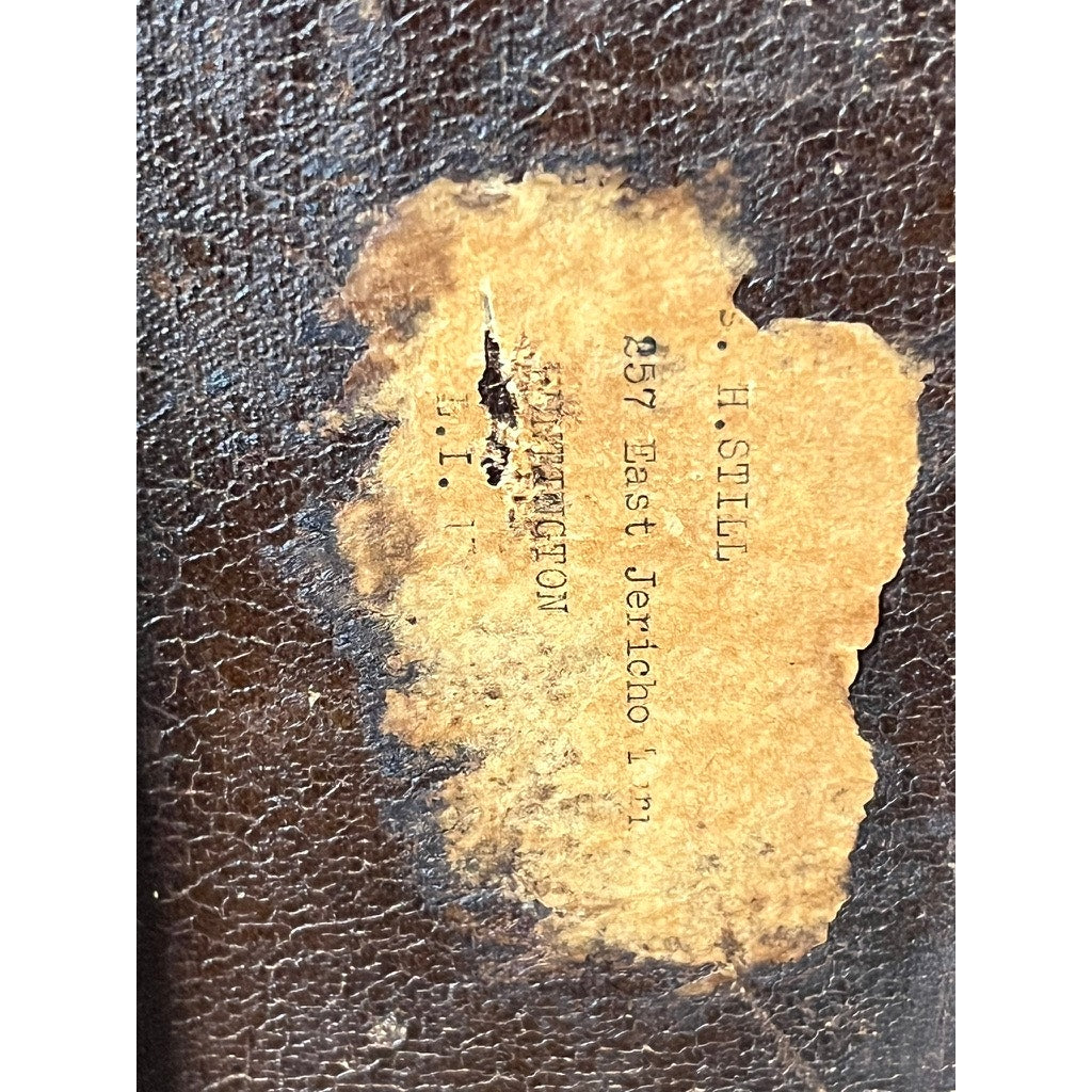 A close-up of a worn brown CA Taylor touring trunk belonging to John B. Cordaro, reed player for the Paul Whiteman Orchestra, c. 1930s. Its faded label reads “257 East Jericho t...N.Y.,” evoking its musical history.