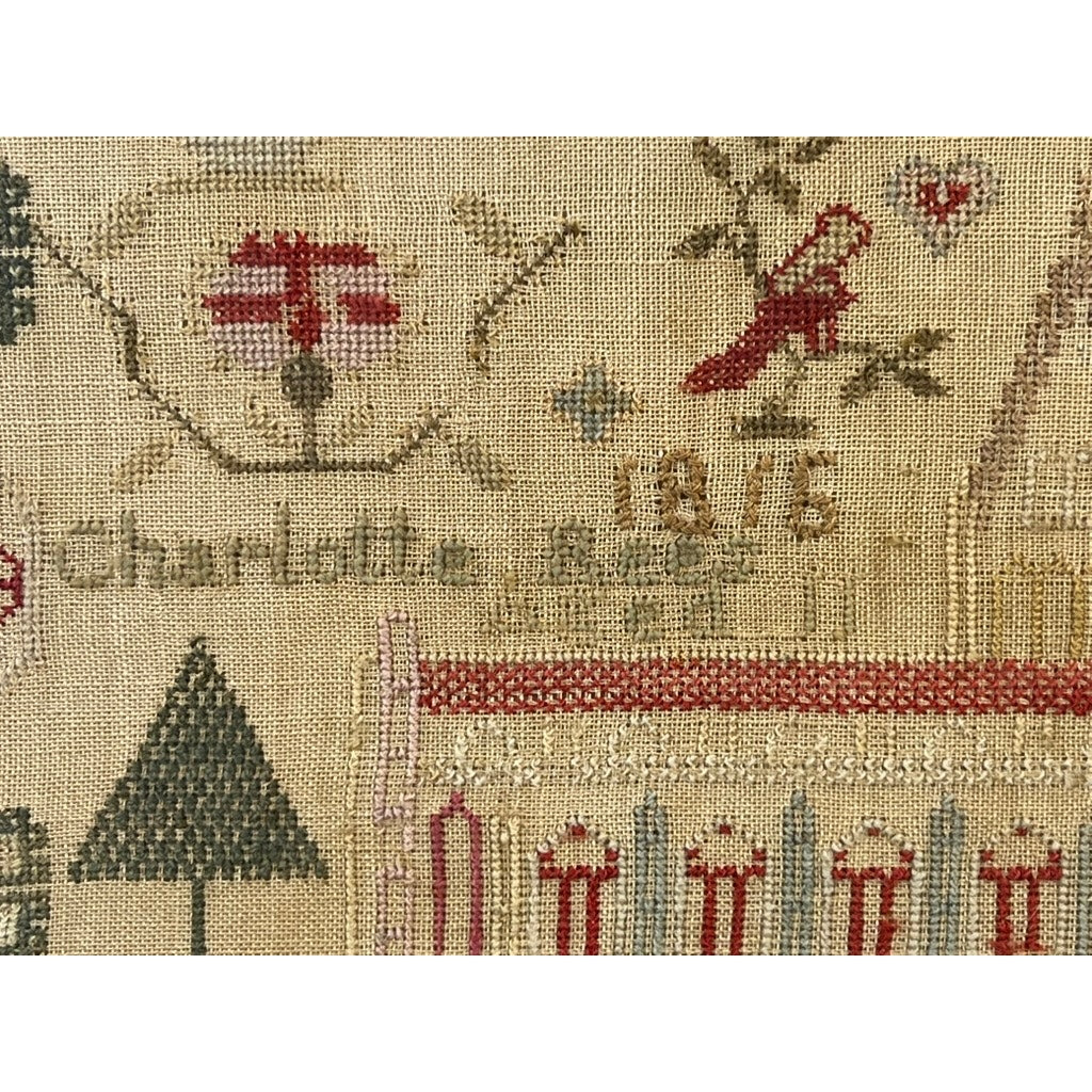 An exceptional English Regency schoolgirl needlework sampler by Charlotte Rees, age 11 and dated 1816, featuring a red bird, a red and white flower, delicate numbers, and Charlotte’s name finely stitched on beige fabric—an exquisite example of early 19th-century needlework artistry.