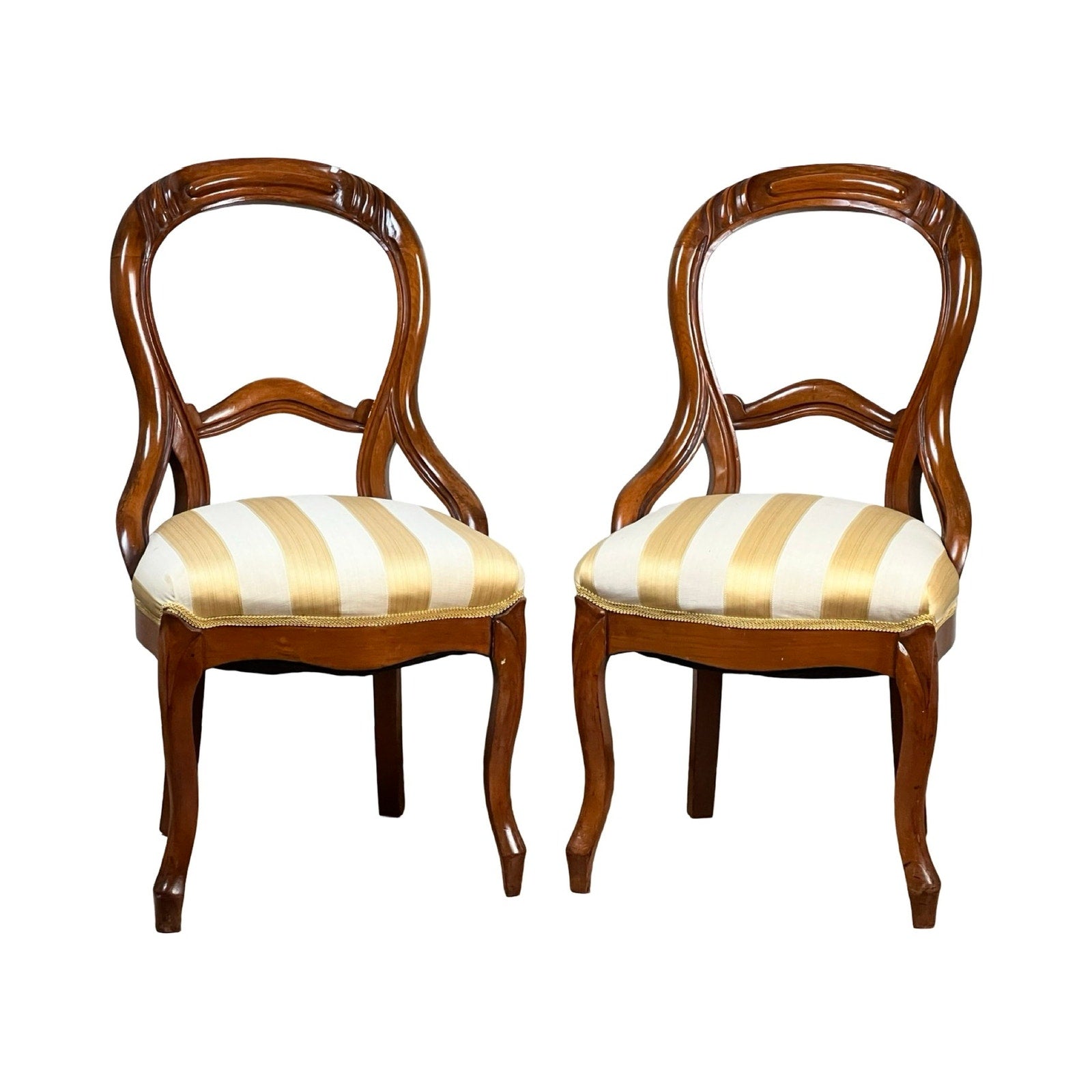 A Pair Antique Victorian Balloon Back Chairs (late 19th century) with ornate, curved backs and yellow-and-white striped cushioned seats, shown side by side against a white background. Brand is unknown.