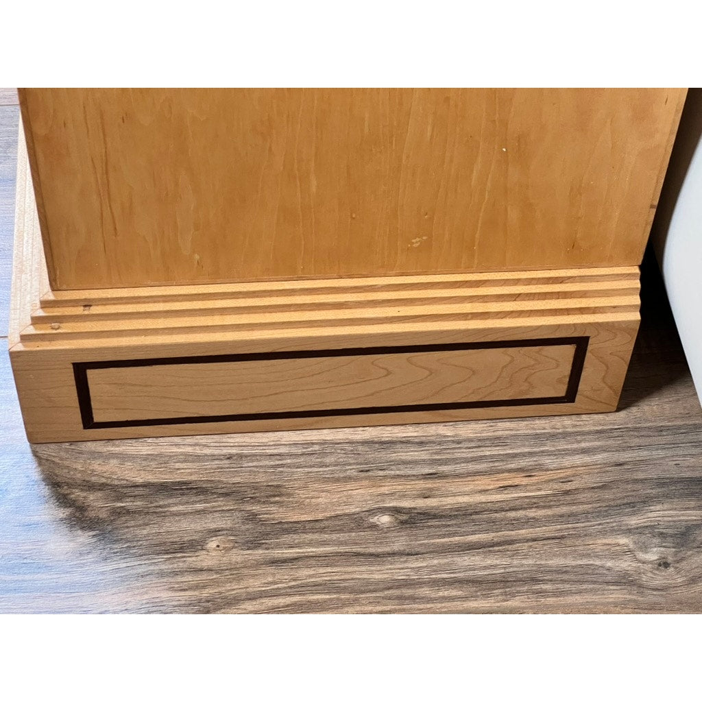 The Vintage Bench Made Maple with Wenge Inlay Three Stack Barrister Bookcase features decorative trim and a rectangular dark wenge inlay on the lower trim, echoing classic barrister styles, and rests on a wood-grain patterned floor.
