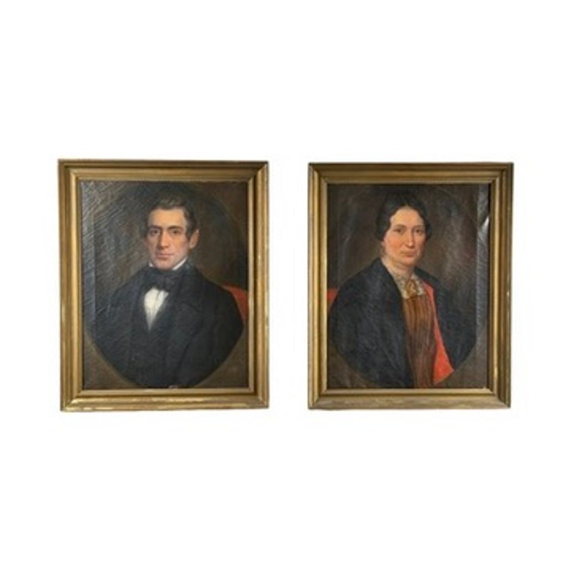Pair of American School Oil Portraits of a Gentleman and Lady, c. 1840–1860, showing two companion portraits of a 19th-century man and woman, each depicted from the chest up in an oval oil painting format.