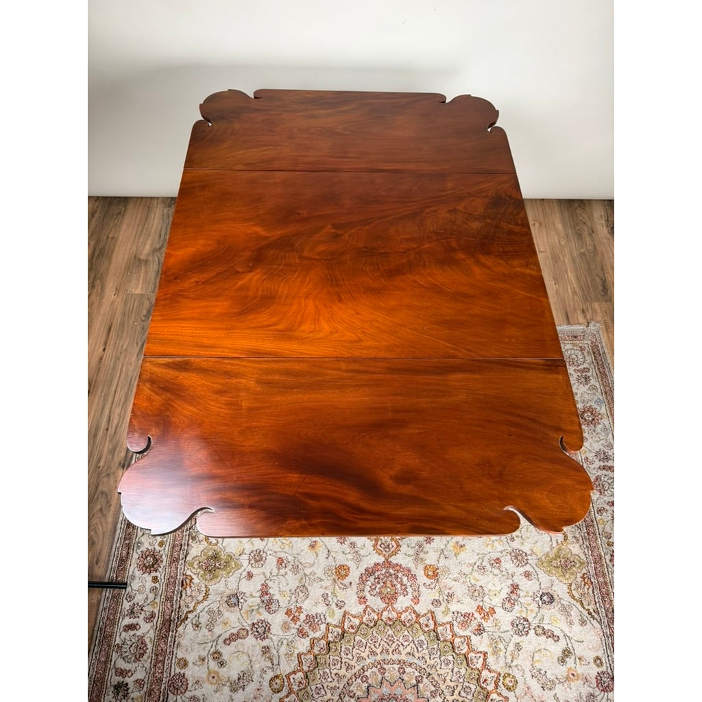 Overhead view of an American Classical Carved Mahogany Drop-Leaf Breakfast Table, c. 1825–1840 Possibly New York or Philadelphia, featuring ornate, scalloped corners.