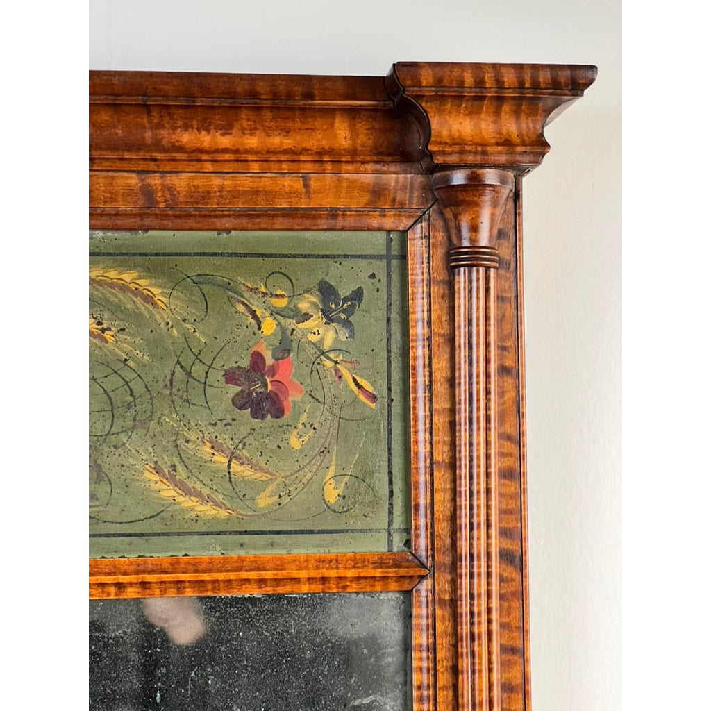 Close-up of a Fine Antique Federal Period Tiger Maple Two Panel Mirror c. 1820, featuring a fluted tiger maple frame and cornice. The upper glass displays painted gold swirls and red, black, and yellow flowers on green. Brand: Unknown.