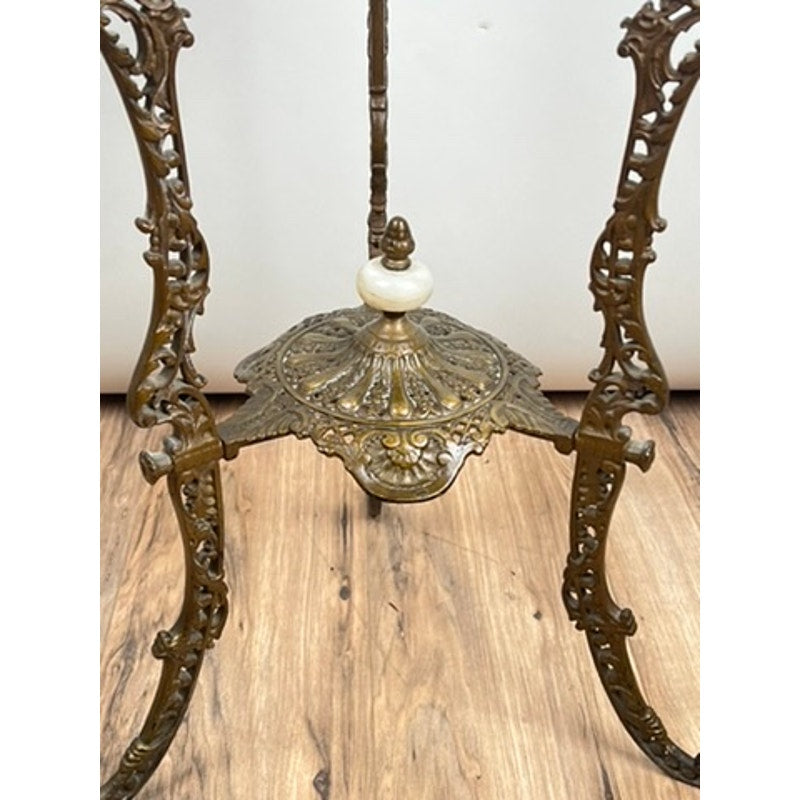 Antique Victorian Bronze and Onyx Stand from the late 19th century featuring ornate scrollwork and a decorative central element, stands on a wooden floor; no tabletop is shown. Brand unknown.