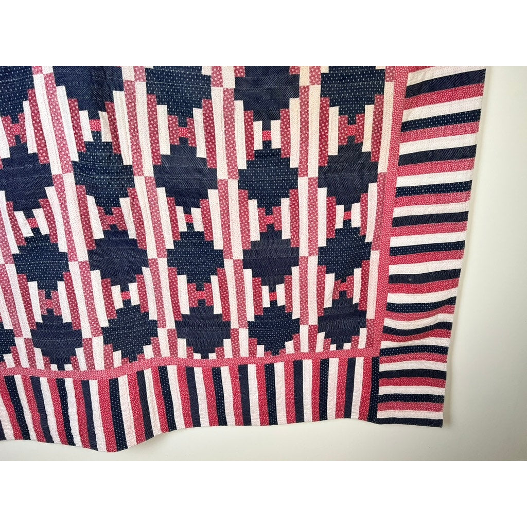 A matching pair of antique American patriotic hand-quilted log cabin quilts (early 20th century) featuring geometric red, white, and blue designs with striped borders evoke classic patriotic style. Brand: None/Unknown.