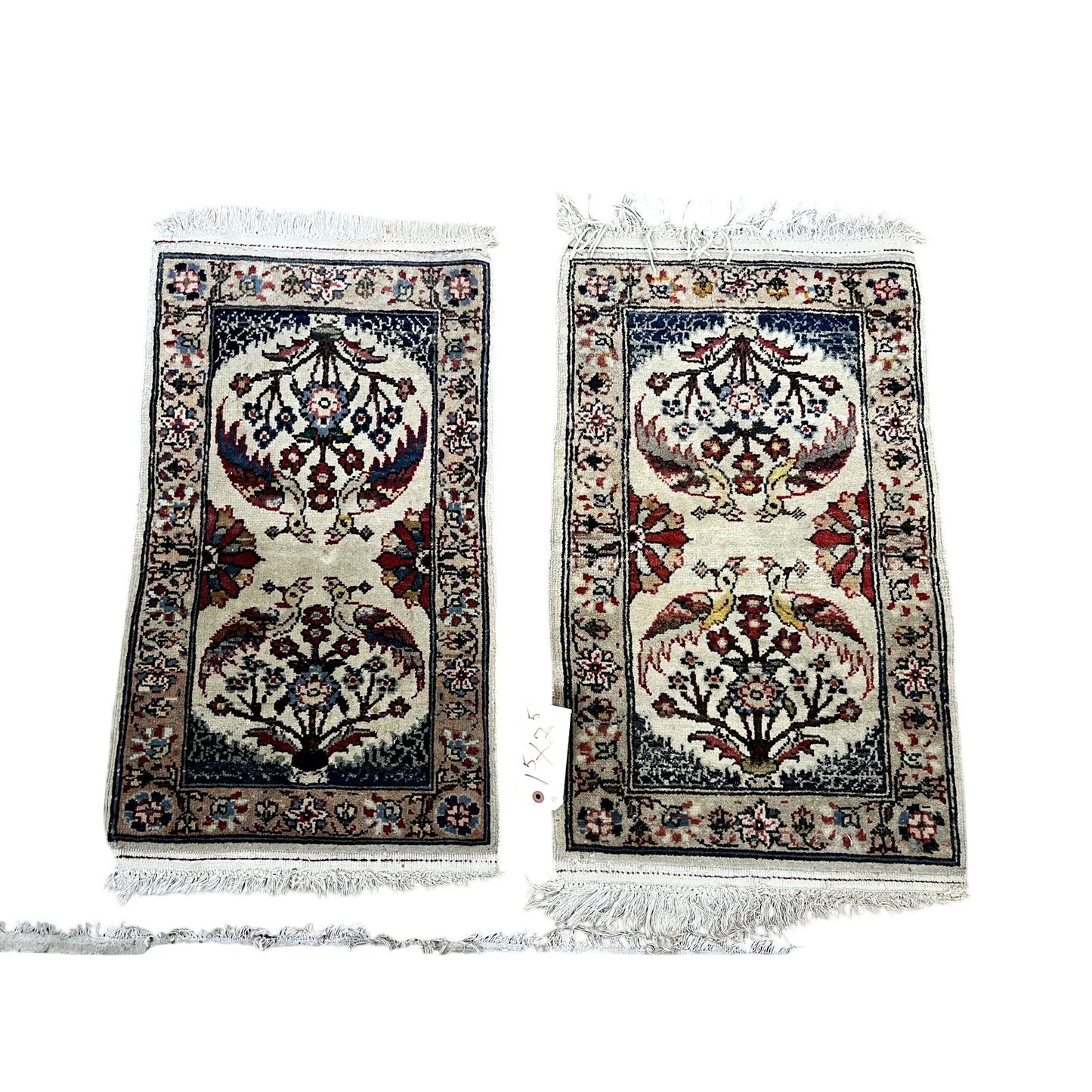 Vintage pair of hand-knotted Oriental Tree of Life scatter rugs (1.5 x 2.5), each with intricate floral patterns in red, blue, cream, and tan, dark blue borders, fringe on short edges, and slight design and size variations.