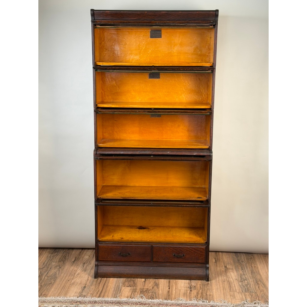 Antique Hale System Quarter-Sawn Oak Five-Stack Barrister Bookcase by Camden Cabinet Company, c. 1910, featuring five glass-fronted oak stacks and two bottom drawers, displayed on a wooden floor against a light-colored wall.