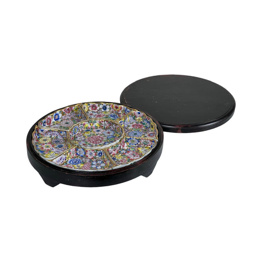 A vintage Chinese Canton Sweet Meat Set from the early 20th century, featuring a round famille rose porcelain dish with colorful floral patterns, short legs, multiple compartments, and a plain dark lid; includes its original case.