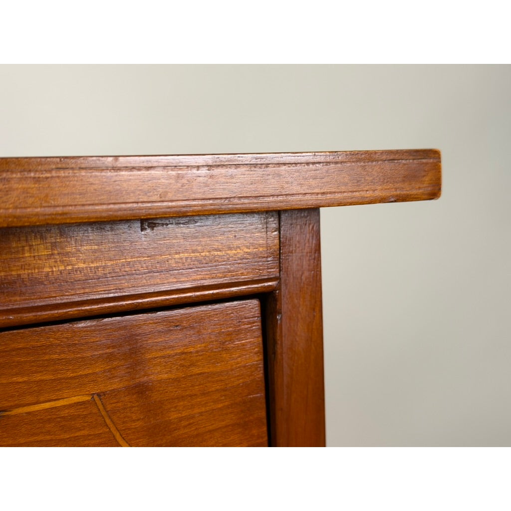 Detail of a Pennsylvania Federal Cherry Four-Drawer Chest with Satinwood String Inlay featuring a top ledge and a drawer with inlaid string detail.