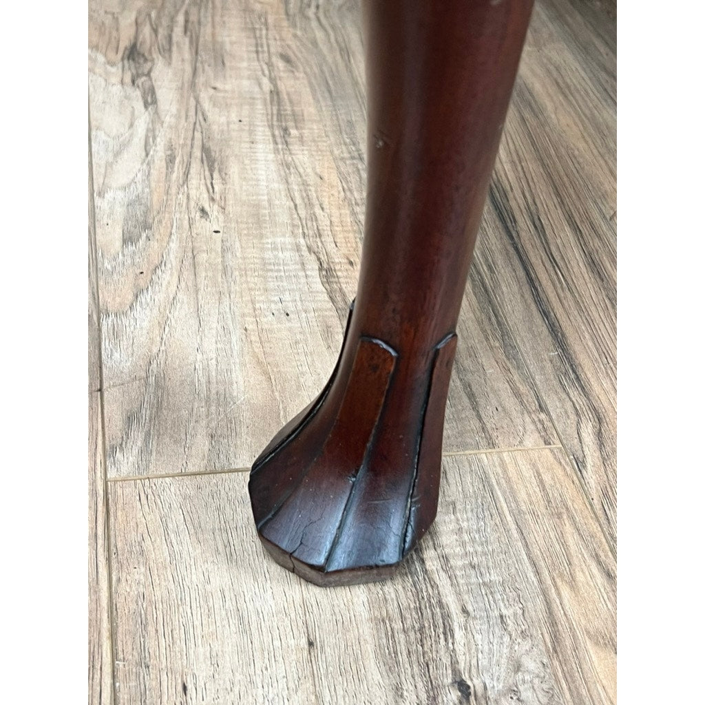 Close-up of an Antique Queen Anne Walnut Chest on Frame with Drake feet, probably Irish c. late 18th century, showing its carved leg and flared foot resting on a light wood floor with visible grain patterns. Brand: Unknown.