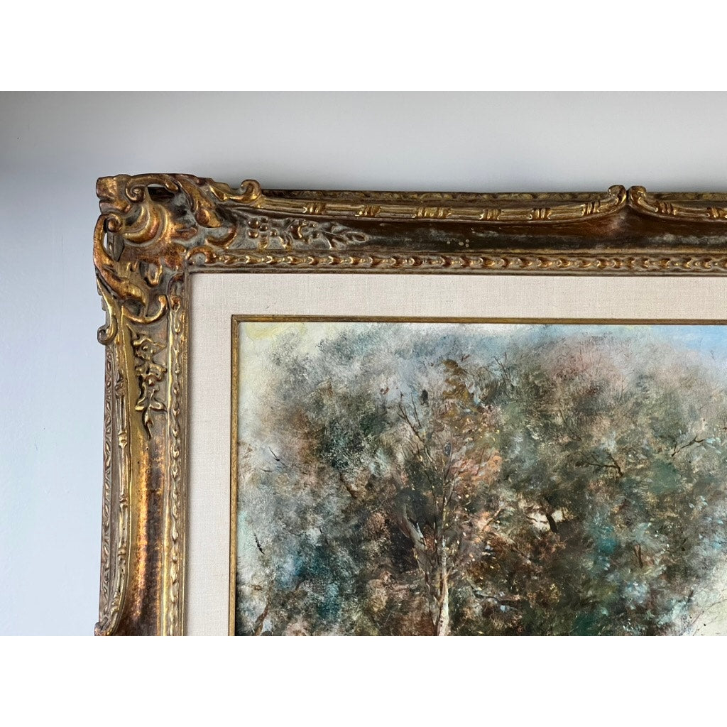 Close-up of the ornate top left corner of a gold frame with detailed carvings, featuring part of a Vintage Guy Cambier Belgian Romantic Landscape Oil Painting with Horsemen, c. 1960–1980, showing textured trees in muted browns and greens.
